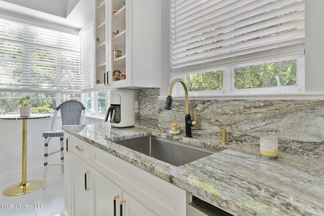 kitchen featuring sink, a wealth of natural light, and white cabinets