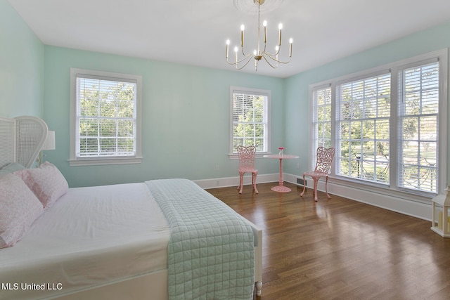 bedroom featuring multiple windows and dark hardwood / wood-style floors