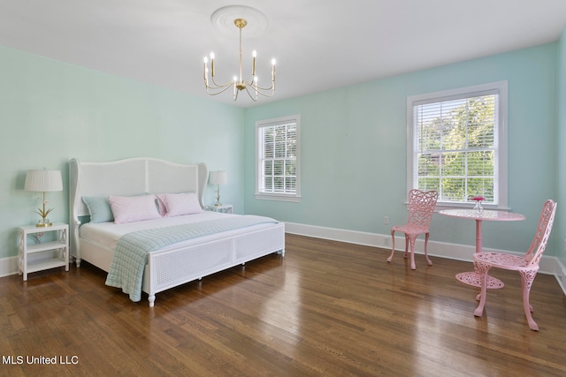 bedroom featuring a notable chandelier and dark hardwood / wood-style flooring