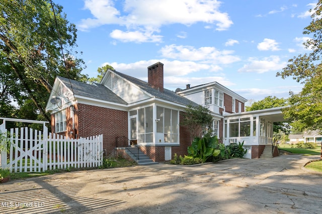 view of front of property featuring a sunroom