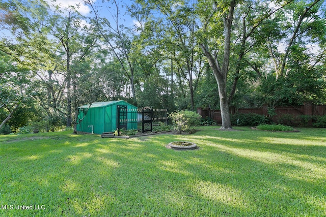 view of yard with a storage unit and a fire pit