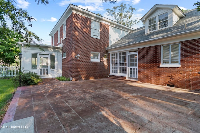 rear view of property featuring a patio area