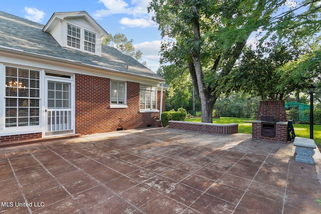 view of patio / terrace featuring a brick fireplace