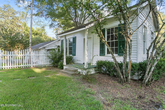 view of home's exterior with a lawn