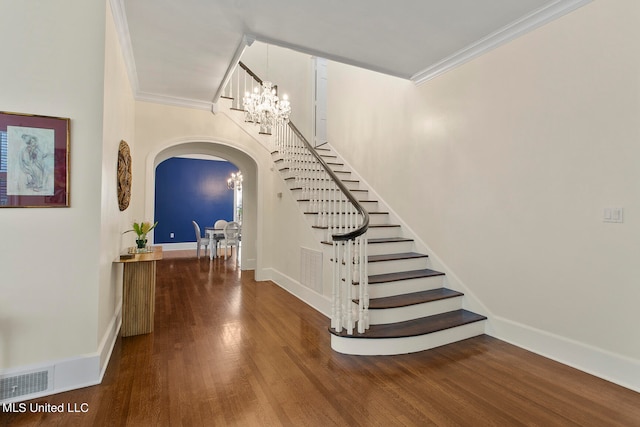 stairs featuring crown molding and hardwood / wood-style flooring