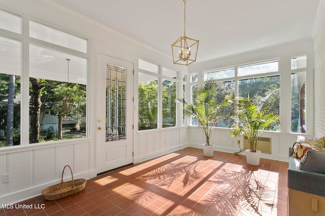 unfurnished sunroom featuring a notable chandelier