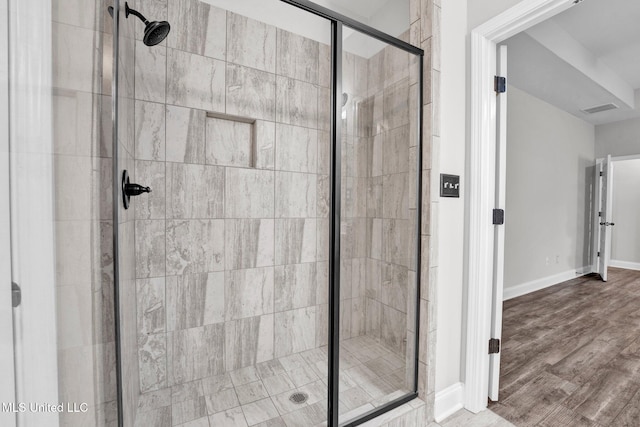 bathroom with walk in shower and wood-type flooring