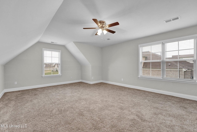 additional living space with ceiling fan, carpet flooring, and vaulted ceiling