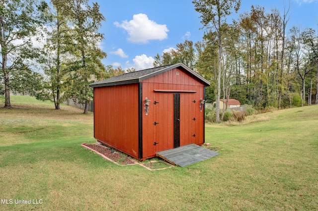 view of outdoor structure with a lawn