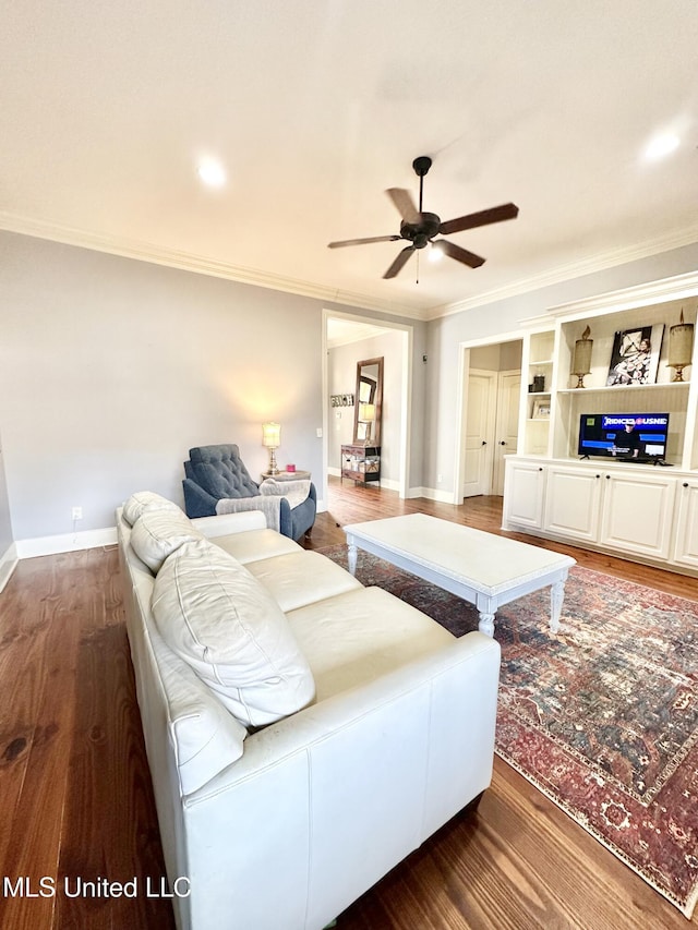 living room with ceiling fan, dark hardwood / wood-style floors, and ornamental molding