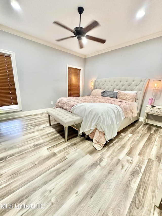 bedroom featuring ceiling fan, light wood-type flooring, and ornamental molding