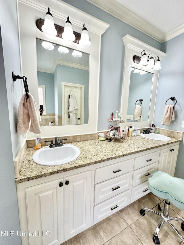 bathroom with crown molding, tile patterned flooring, and vanity