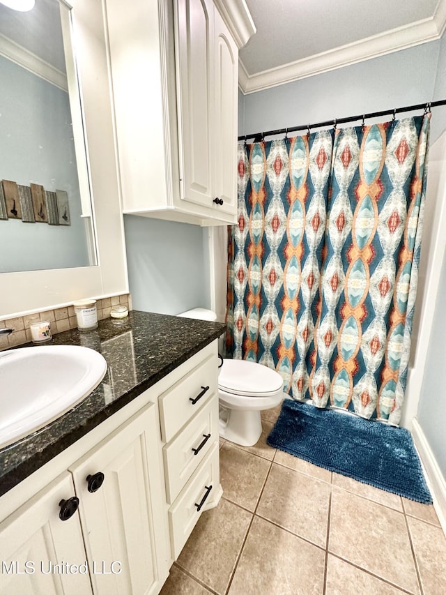 bathroom featuring tile patterned floors, vanity, toilet, and crown molding