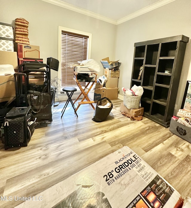 misc room featuring wood-type flooring and ornamental molding