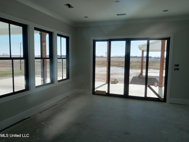1400 Bayou Dr, Indianola, MS 38751 - empty room featuring healthy amount of natural light, concrete flooring, and baseboards