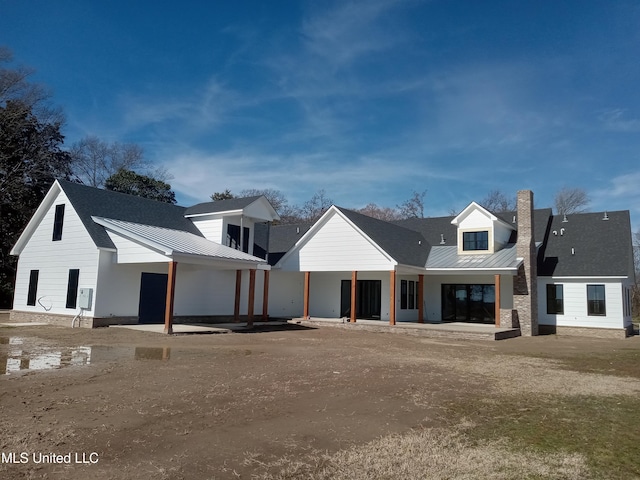 1400 Bayou Dr, Indianola, MS 38751 - view of front of home with a standing seam roof, metal roof, and a chimney