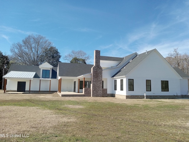 1400 Bayou Dr, Indianola, MS 38751 - back of property featuring a chimney, a lawn, and roof with shingles