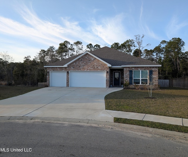 view of front facade featuring a front yard, fence, an attached garage, concrete driveway, and brick siding