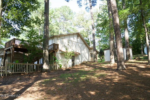 view of side of home with a deck