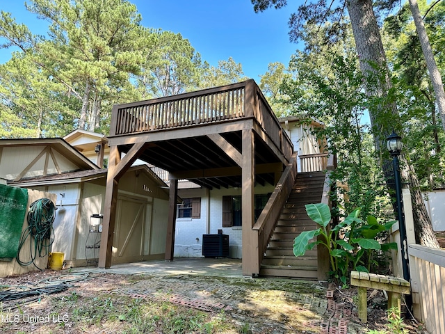 back of house with a patio area and a wooden deck