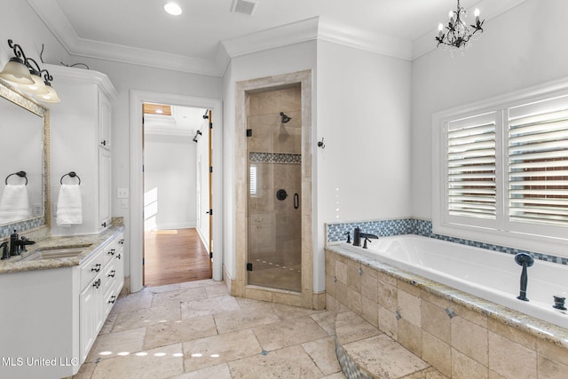 bathroom with vanity, an inviting chandelier, ornamental molding, and shower with separate bathtub