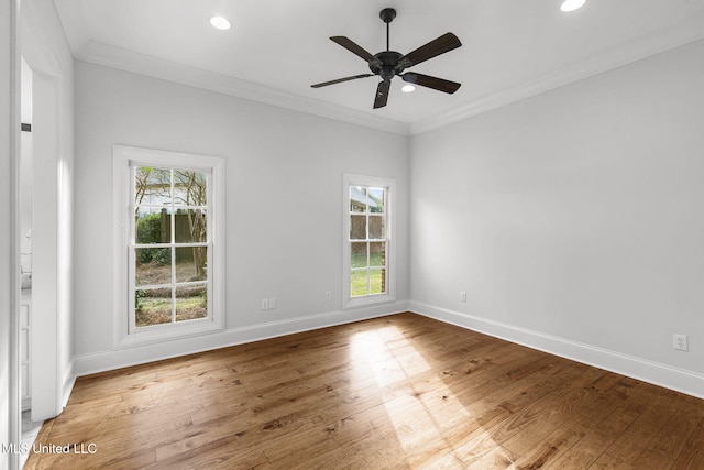 spare room featuring ornamental molding, a wealth of natural light, and hardwood / wood-style floors