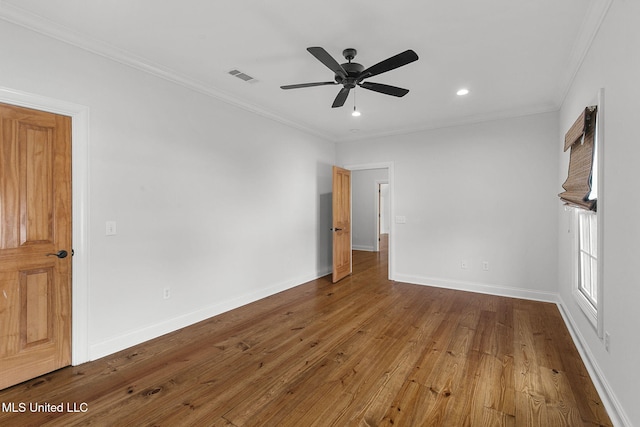 spare room with crown molding, wood-type flooring, and ceiling fan