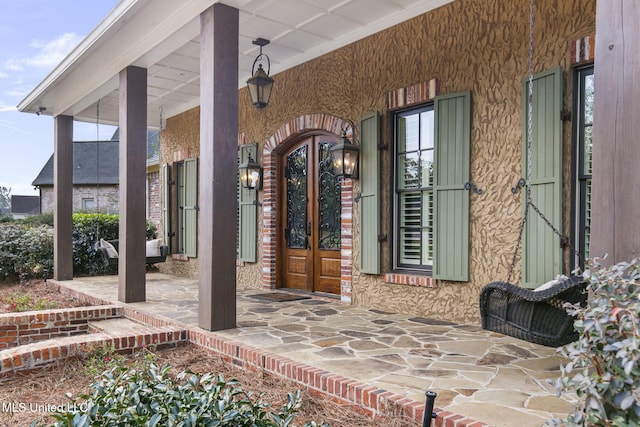 property entrance featuring covered porch