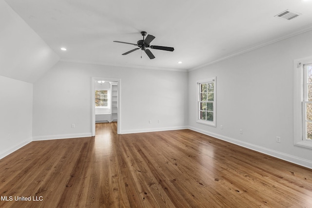 unfurnished living room featuring ceiling fan, a healthy amount of sunlight, lofted ceiling, and hardwood / wood-style floors