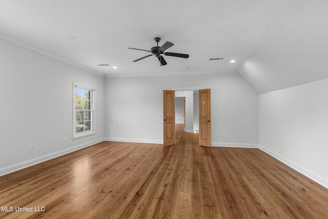 interior space featuring ornamental molding, hardwood / wood-style floors, ceiling fan, and vaulted ceiling