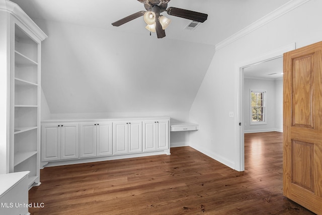 bonus room featuring lofted ceiling, dark hardwood / wood-style floors, built in desk, and ceiling fan