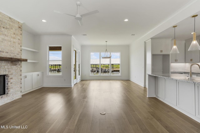 101 Harbour Lndg, Madison, MS 39110 - unfurnished living room featuring a brick fireplace, a ceiling fan, baseboards, recessed lighting, and wood finished floors