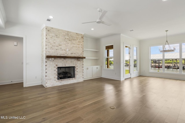 101 Harbour Lndg, Madison, MS 39110 - unfurnished living room with ceiling fan, baseboards, wood finished floors, a brick fireplace, and ornamental molding