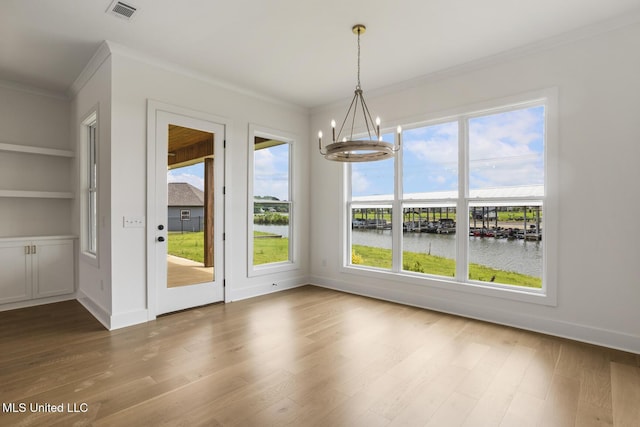 101 Harbour Lndg, Madison, MS 39110 - unfurnished dining area with crown molding, a chandelier, a water view, wood finished floors, and built in shelves