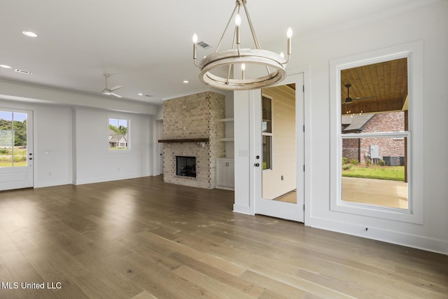 101 Harbour Lndg, Madison, MS 39110 - unfurnished living room with plenty of natural light, ceiling fan, wood finished floors, a fireplace, and crown molding