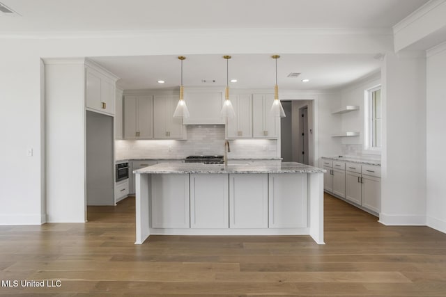 101 Harbour Lndg, Madison, MS 39110 - kitchen featuring open shelves, tasteful backsplash, wood finished floors, white cabinets, and a center island with sink