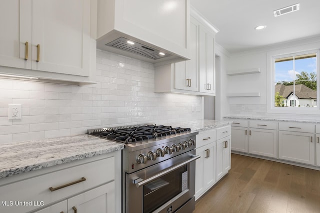 101 Harbour Lndg, Madison, MS 39110 - kitchen with high end range, open shelves, wood finished floors, white cabinets, and tasteful backsplash