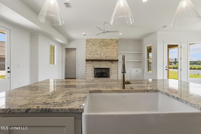 101 Harbour Lndg, Madison, MS 39110 - kitchen with open floor plan, ceiling fan, light stone counters, recessed lighting, and a fireplace