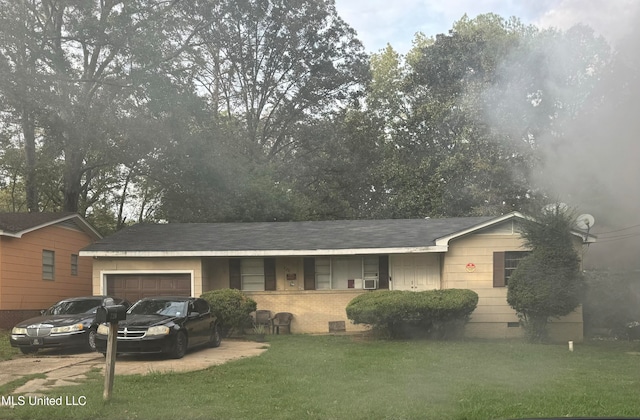 single story home with a garage and a front lawn