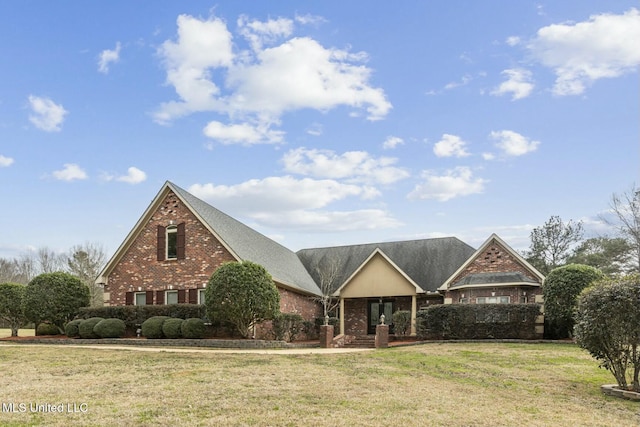 traditional home with brick siding and a front lawn