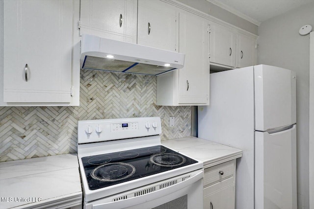 kitchen featuring tasteful backsplash, white appliances, tile counters, and white cabinets