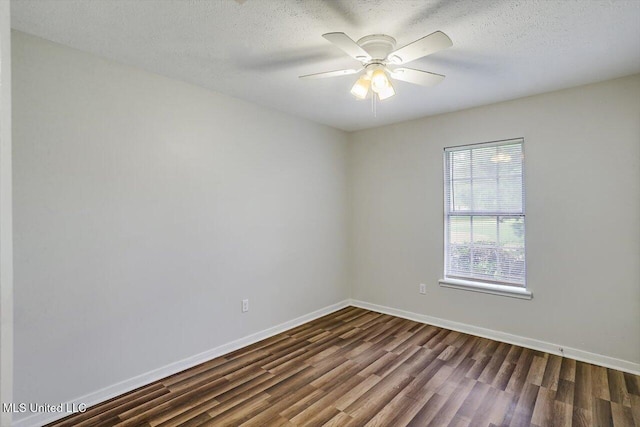 empty room featuring a textured ceiling, dark hardwood / wood-style floors, and ceiling fan