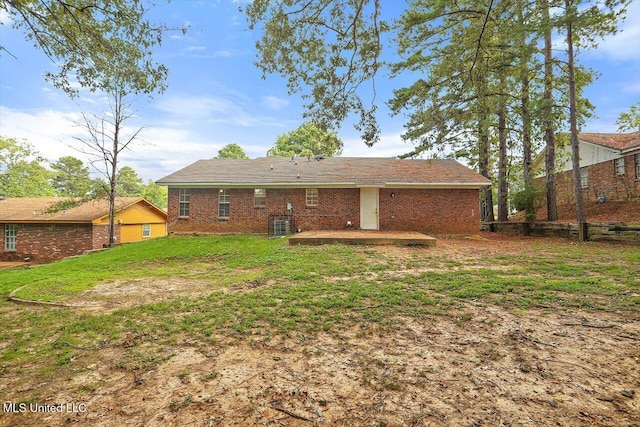 rear view of property with a yard