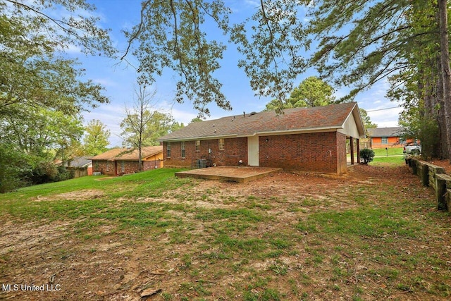 back of property featuring a patio and a lawn