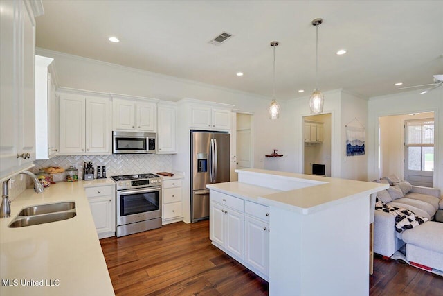 200 Falls Xing, Madison, MS 39110 - kitchen featuring stainless steel appliances, backsplash, crown molding, open floor plan, and a center island
