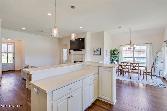 200 Falls Xing, Madison, MS 39110 - kitchen with open floor plan, a chandelier, a center island, light countertops, and dark wood-style floors