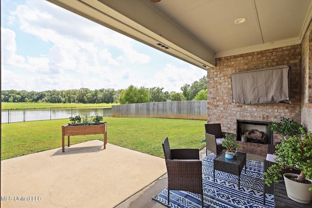 200 Falls Xing, Madison, MS 39110 - fenced backyard with a patio area, a water view, and an outdoor living space with a fireplace