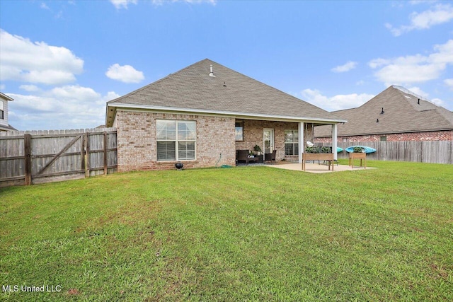 200 Falls Xing, Madison, MS 39110 - rear view of house with a patio, a fenced backyard, a shingled roof, and brick siding
