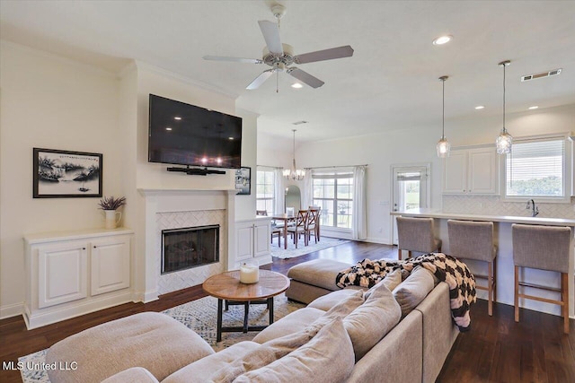 200 Falls Xing, Madison, MS 39110 - living area with dark wood-type flooring, ceiling fan, recessed lighting, and a tiled fireplace