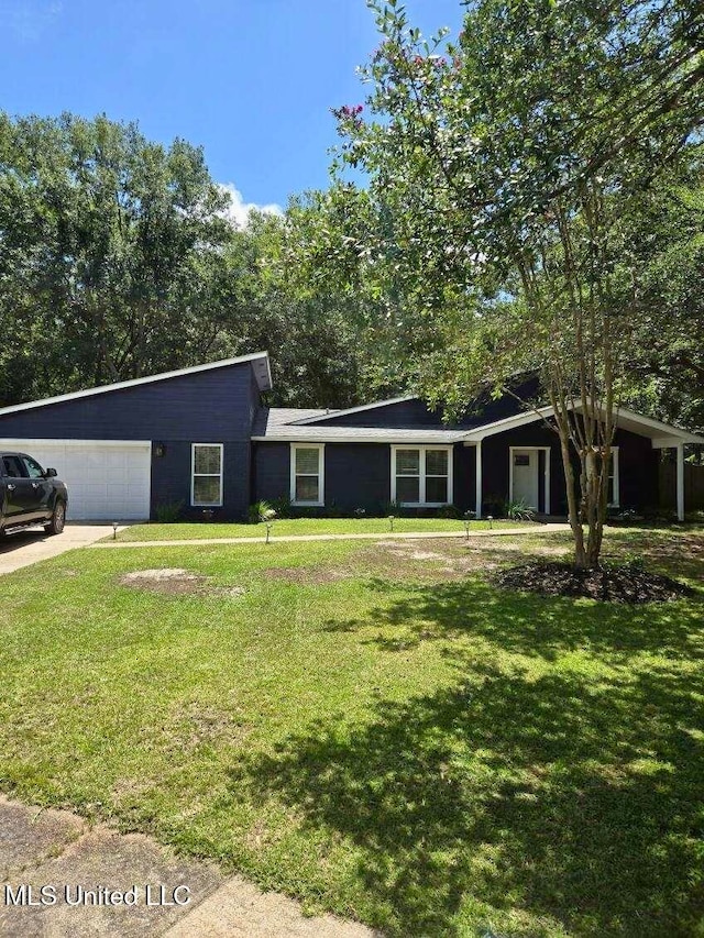 ranch-style home with a garage and a front lawn